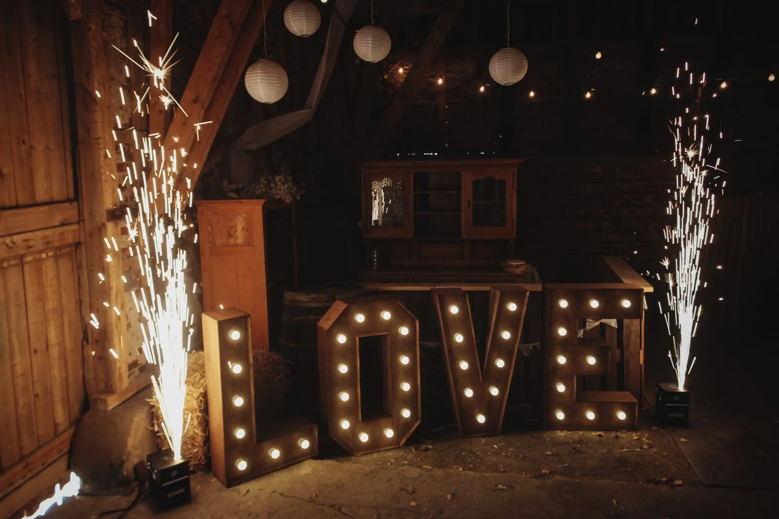 Beispielbild: Zwei Funkenfontänen links und rechts neben LOVE-Buchstaben in einer Scheune